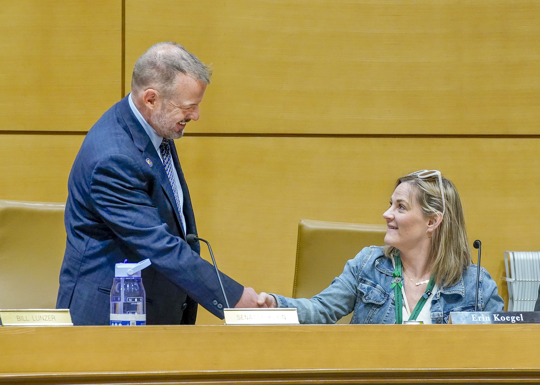 Sen. Matt Klein and Rep. Erin Koegel greet each other before settling in for a May 12 conference committee on HF4188, the commerce policy bill. (Photo by Andrew VonBank)